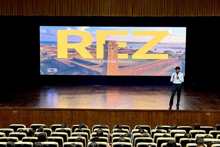 Sukhith on stage in an auditorium